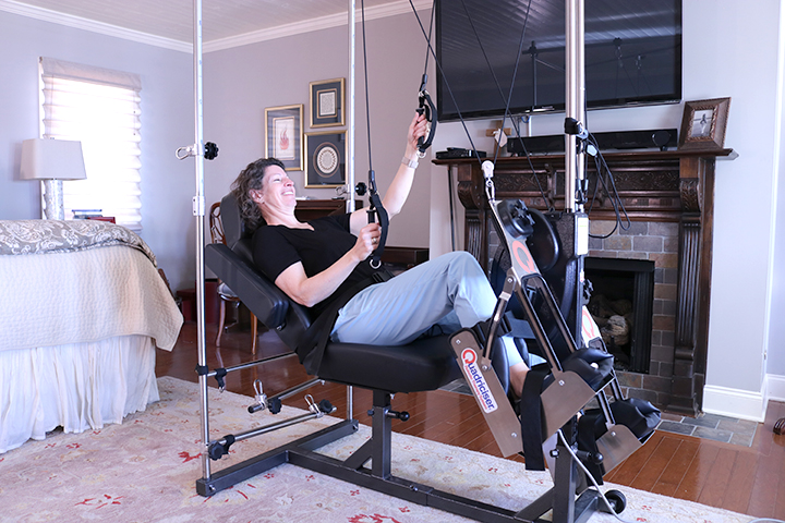 woman on the quadriciser in her bedroom working out